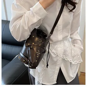 Detailed view of horse skull punk crossbody bag with bronze studs and retro badges