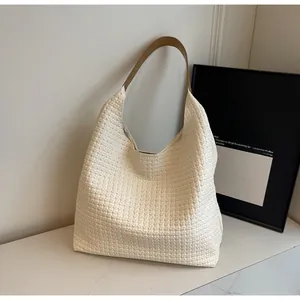 Macro detail of high-quality white woven texture and brown leather strap on tote bag