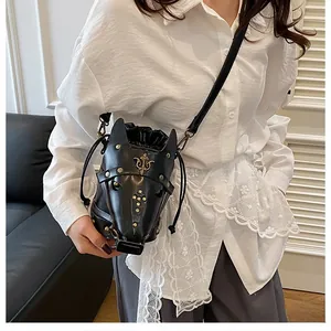 Detailed close-up of horse-head shaped black leather crossbody bag with gold studs