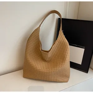Detailed texture of the woven leather pattern on the large light brown shoulder tote bag