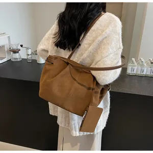 Detail view of caramel suede tote bag with matching strap and detachable coin purse