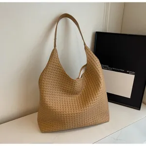 Detail of the soft woven texture and camel leather finish on this large hobo tote bag