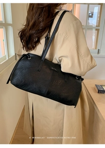 Detail of vintage black textured shoulder bag with MUTING logo and drawstring detail
