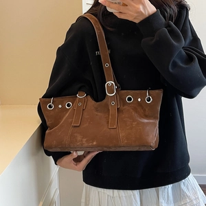 Brown vintage faux leather shoulder bag with silver rivet details and Y2K motorcycle style