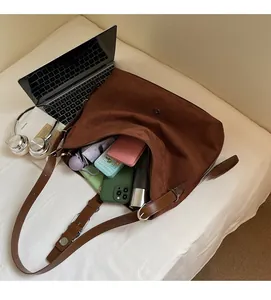 Macro view of spacious interior in a brown suede tote bag showing everyday storage