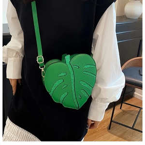 Detail of green leaf-shaped PU leather crossbody bag with sparkling sequin vein patterns
