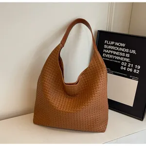 Close-up of brown woven leather texture on a spacious Hobo commuter tote bag