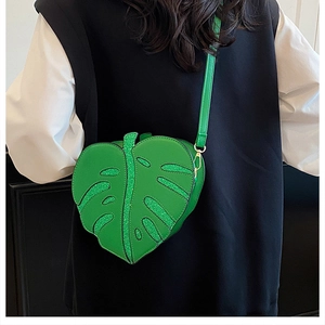 Detail of green leaf-shaped crossbody bag featuring shimmering sequins on fine PU leather