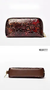 Detailed back and bottom view of bronze embossed floral PU wristlet bag with zipper