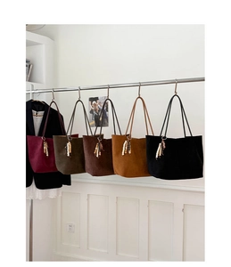 Detail showing five vintage tote bags in suede texture with unique wooden bead charms