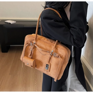 Brown faux suede tote bag with belt buckle detail and small hanging zip pouch