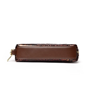 Retro caramel brown leather wristlet with embossed floral design and gold zipper