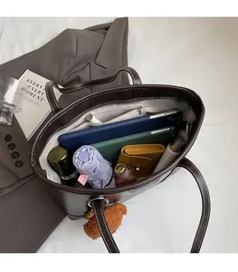 Top view showing large interior capacity of dark brown tote bag with contrast stitching