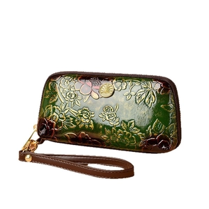 Retro green leather clutch bag with golden floral embossing and wrist strap