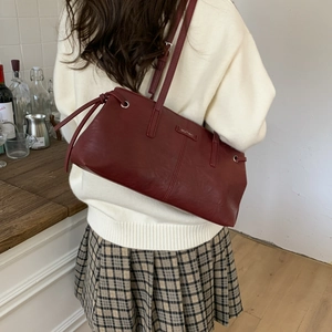 Retro burgundy matte PU leather shoulder bag shown from a rear perspective on a model