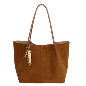 Brown suede tote bag with large capacity featuring a minimalist design and beaded tassel