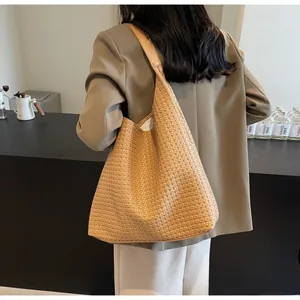Detail of light brown woven hobo bag showing high-quality leather texture and large capacity