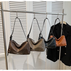 Detail of trendy vintage hobo bags in multiple colors hanging on a display rack