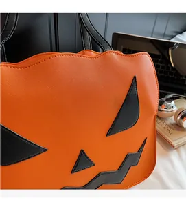 Nahaufnahme der Saffiano-Kunstledertextur und des Kürbisgesichts auf der orangefarbenen Tasche