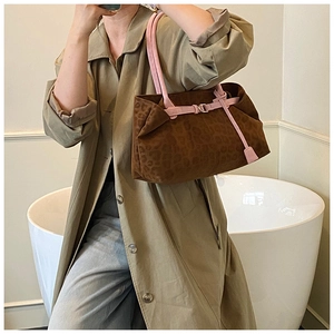 Detail of leopard print tote bag with pink leather strap and soft suede texture