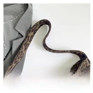 Detail shot of the wide leopard print shoulder strap on a soft faux suede tote bag