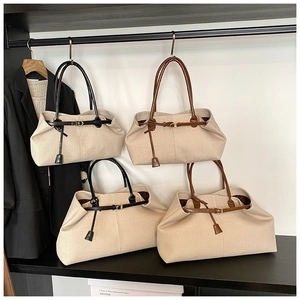 Detail view of large and small canvas tote bags with leather trim in two color options