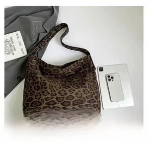 Detailed top view of leopard print tote bag with soft suede texture and wide shoulder strap