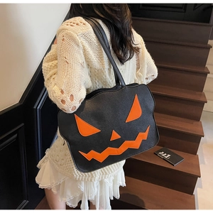 Close-up of the Halloween pumpkin tote bag featuring a leather Jack-o'-lantern face design