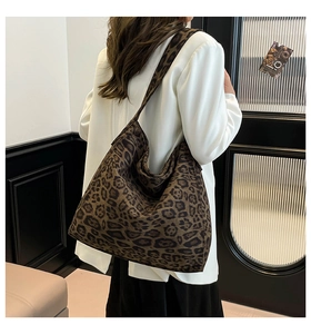 Detail of a large leopard print tote bag featuring a soft texture and spacious hobo design