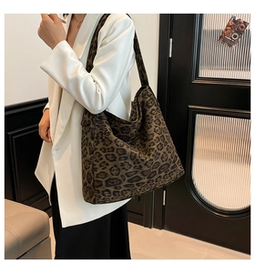 Close-up of leopard print oversized hobo tote bag in suede fabric texture