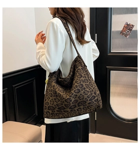 Detail of leopard print tote bag showing soft suede texture and wide shoulder strap