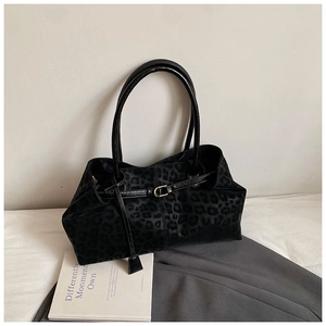 Detailed view of leopard print tote bag with soft faux fur texture and gold buckle