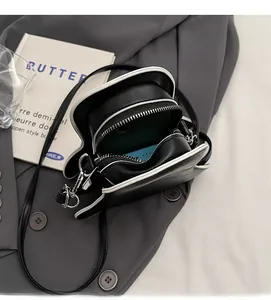 Dual zipper opening of ghost crossbody bag showing spacious interior compartment