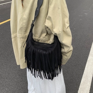 Chic black fringe shoulder bag in faux suede, bohemian tassel style for women