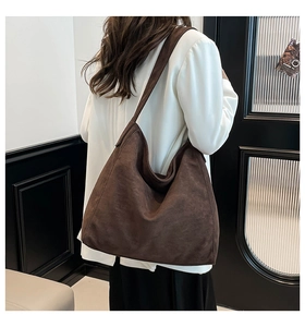 Side view of large brown faux suede tote bag showing soft texture and wide shoulder strap