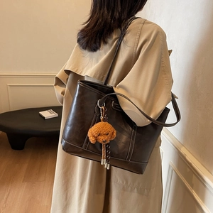 Retro brown leather tote bag with contrast stitching and teddy charm for women