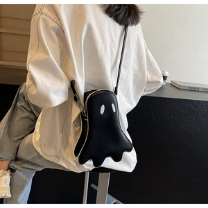 Rear view of a model wearing the black ghost-shaped crossbody bag over a white t-shirt