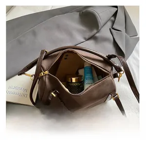 Top view of brown Boston bag interior showing spacious capacity for daily essentials