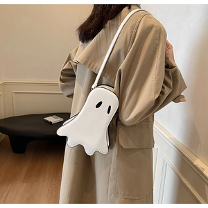 Detail view of a white ghost-shaped crossbody bag with smooth PU finish on a model's shoulder