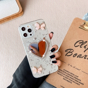 Custodia iPhone glitterata in lamina d'argento con farfalle rosa e specchio a cuore