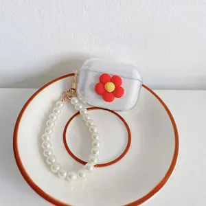 Close-up of clear AirPods case with 3D red sunflower and elegant pearl strap