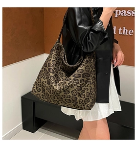 Leopard print tote bag showing large capacity and soft slouchy texture on a model