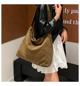 Detailed view of the dark brown suede hobo bag showing retro stitching and large capacity