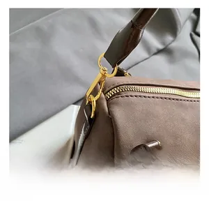 Detail of high-quality gold hardware hook and premium matte texture on a Boston handbag