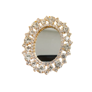 Macro detail of oval rhinestone mirror phone stand with sparkling crystal border