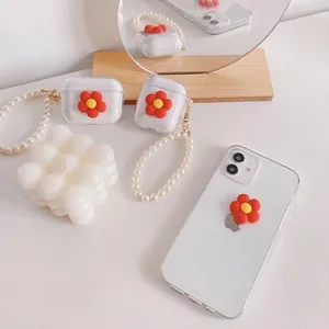 Detail of clear AirPods case with 3D red flower and decorative pearl bead strap