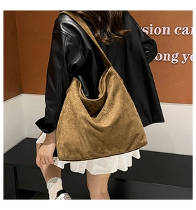Suede tote bag shown on model highlighting spacious capacity and slouchy vintage hobo style