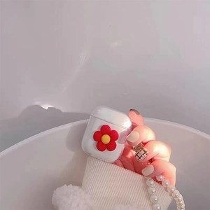 Clear TPU case for AirPods featuring a red floral charm and pearl lanyard detail