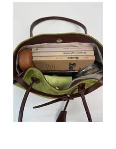 Top view of spacious green suede tote bag showing large capacity for books and umbrella