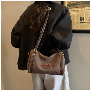 Retro mocha brown suede Boston bag detail with sleek leather straps and gold metal hardware